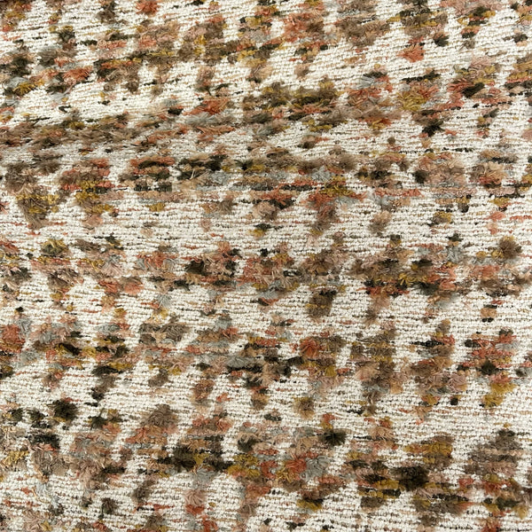 Textured fabric with a pattern of brown, beige, and black colors.