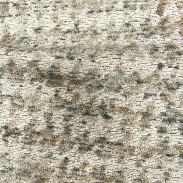 Textured fabric with a pattern of brown, beige, and black colors.