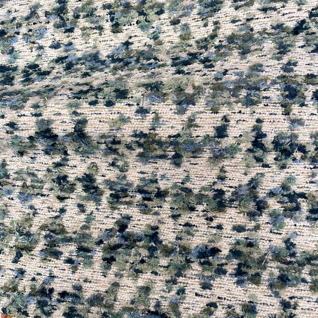 Textured pattern with earthy tones and small green elements